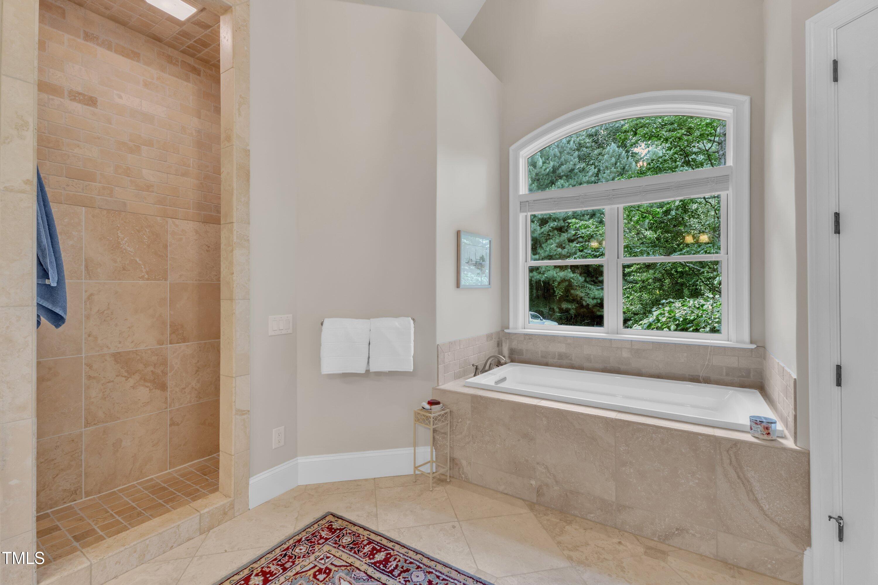 1004 Tobiano Lane Raleigh, NC 27614 - Photo 21 of 48 a bathroom with a bathtub and window