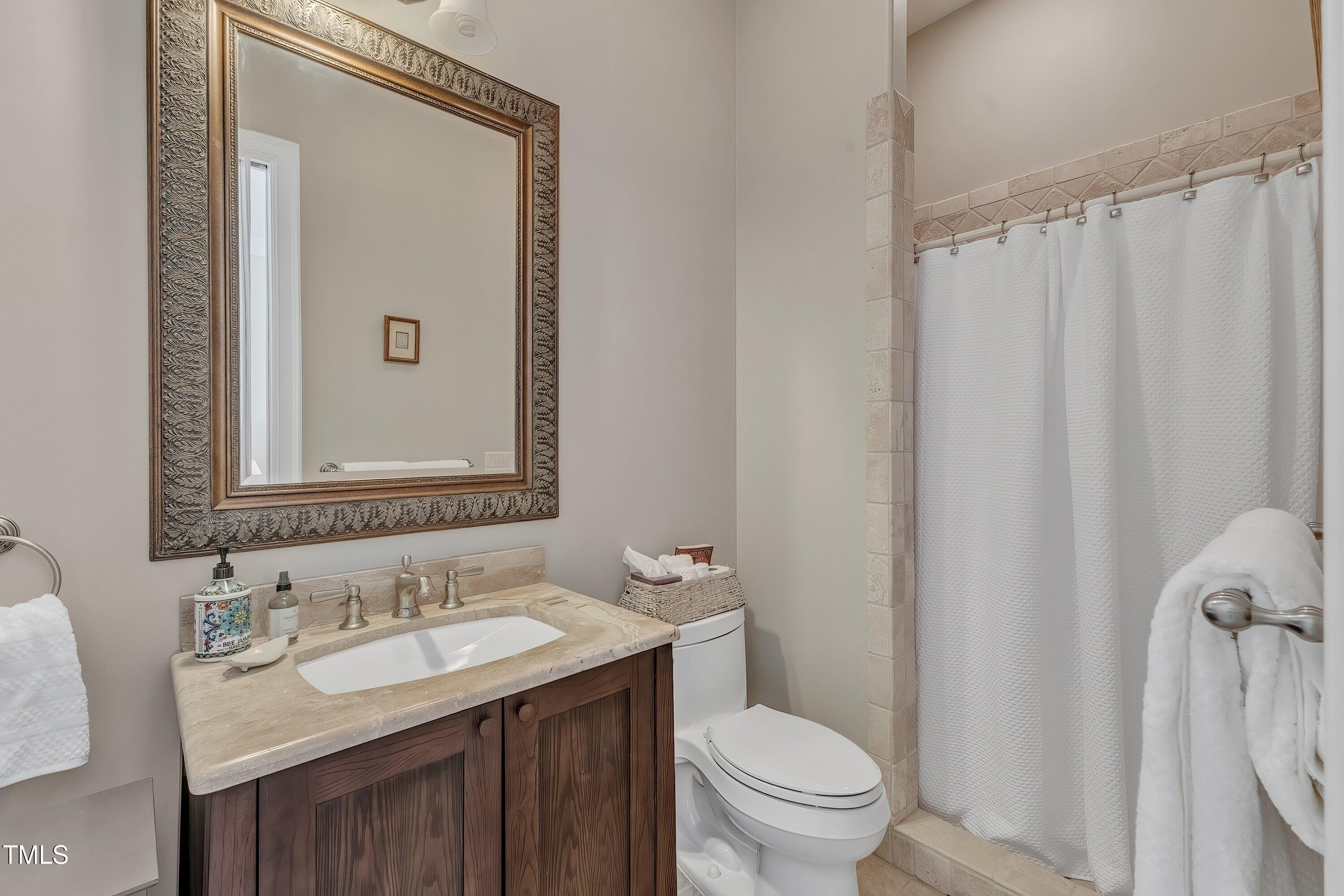 1004 Tobiano Lane Raleigh, NC 27614 - Photo 25 of 48 a bathroom with a sink toilet and shower