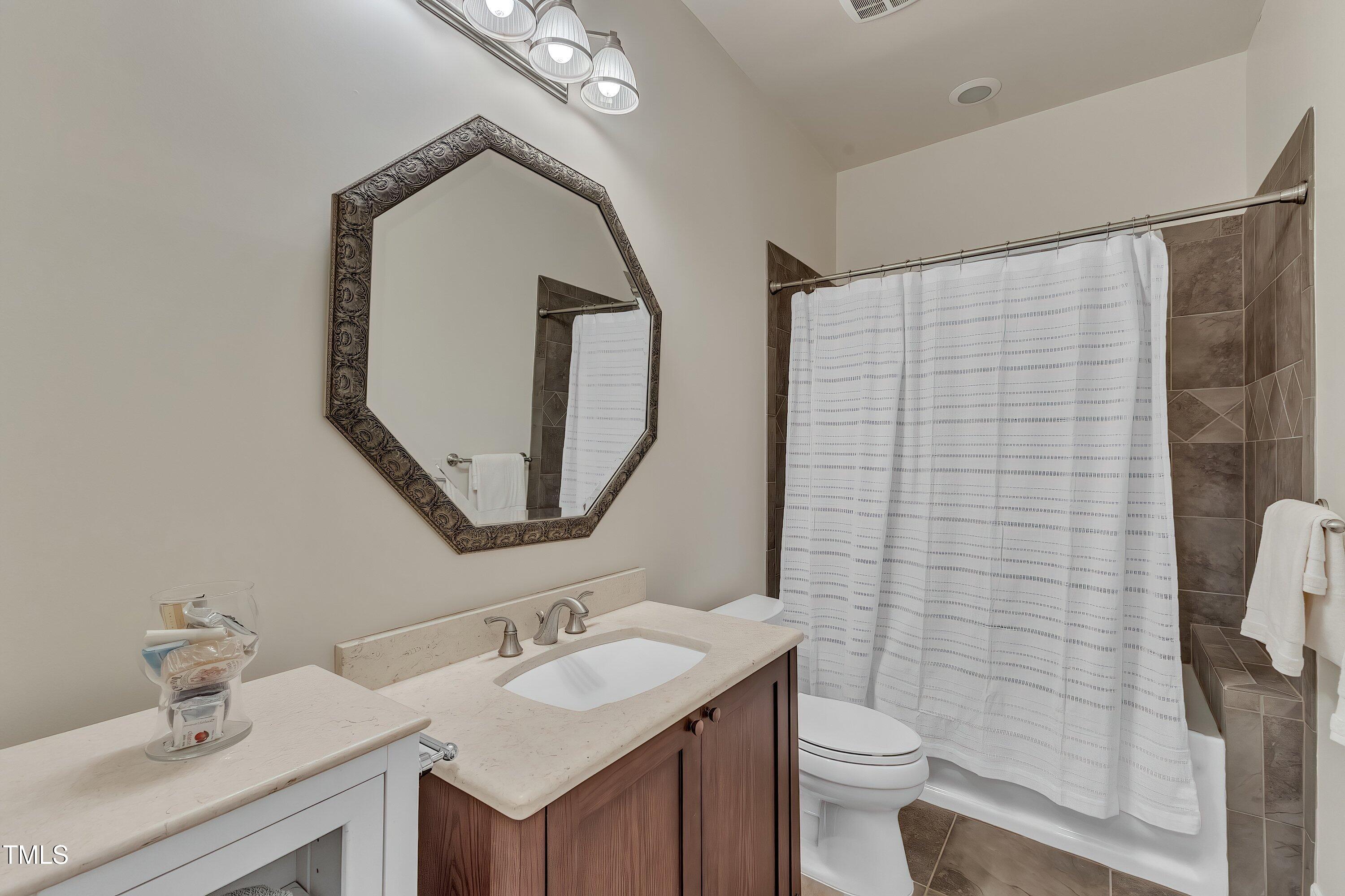 1004 Tobiano Lane Raleigh, NC 27614 - Photo 38 of 48 a bathroom with a sink vanity mirror and toilet