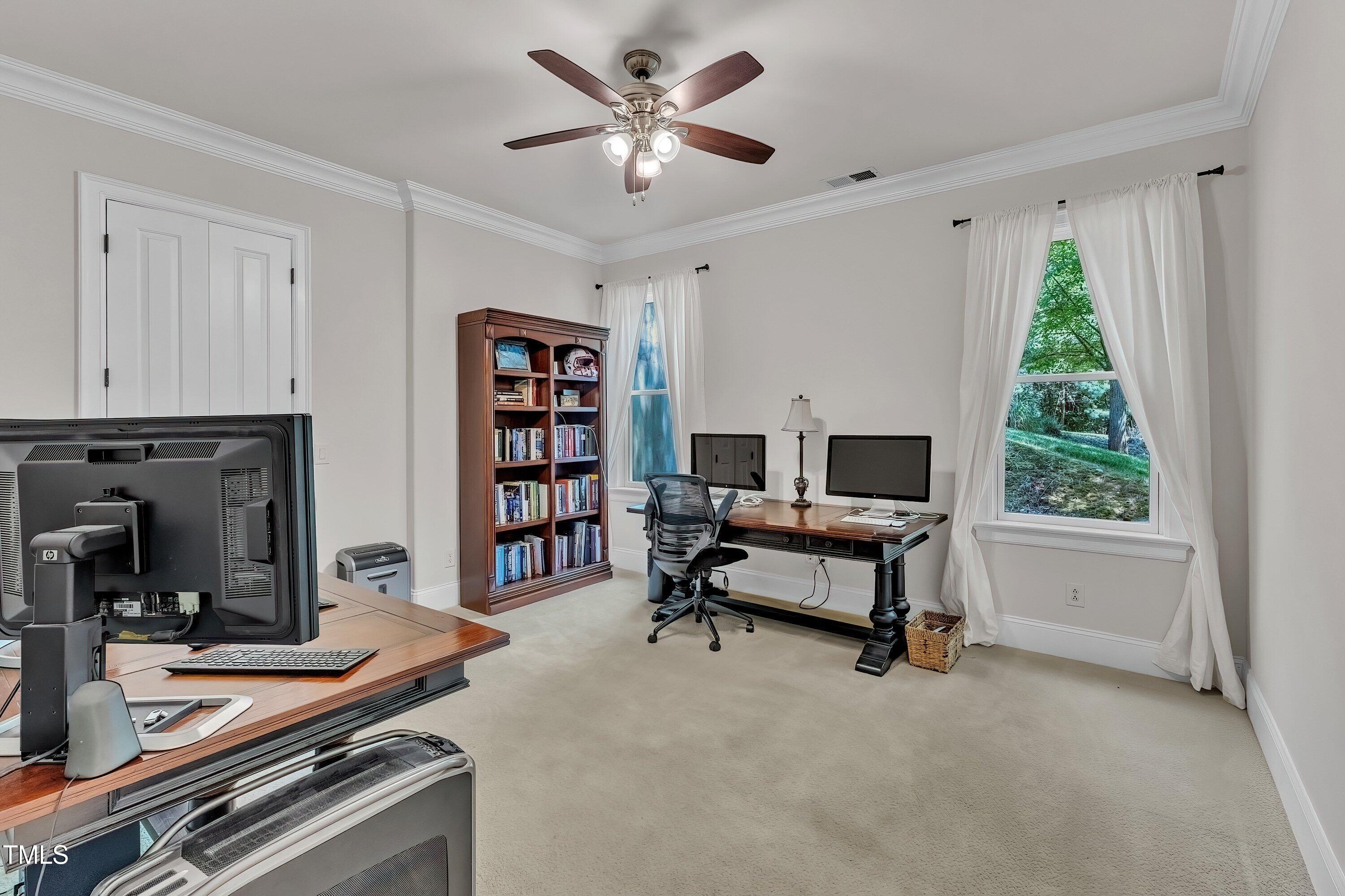 1004 Tobiano Lane Raleigh, NC 27614 - Photo 39 of 48 a living room with furniture a bookshelf and a window