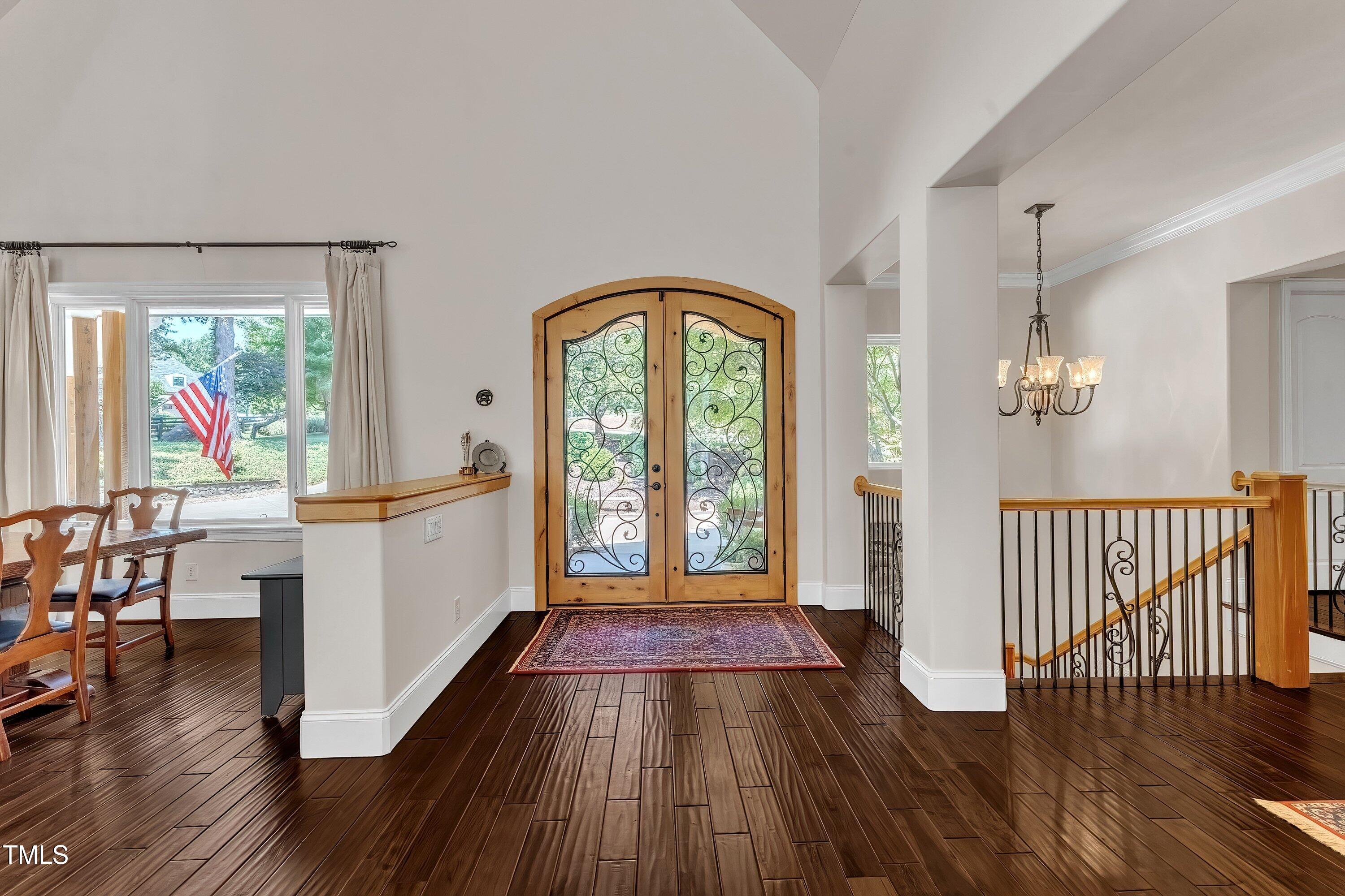 1004 Tobiano Lane Raleigh, NC 27614 - Photo 5 of 48 a very nice looking room with wooden floor windows and a chandelier