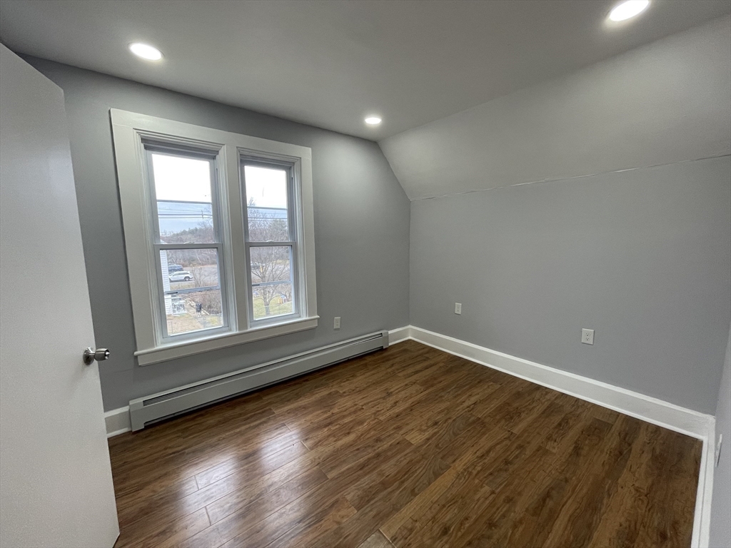 59 High Street Warren, MA 01083 - Photo 25 of 42 a view of an empty room with wooden floor and a window