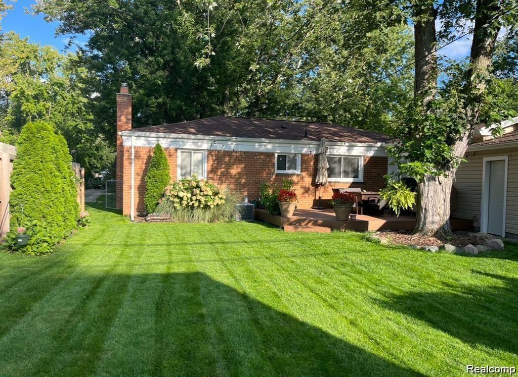1341 Catalpa Drive Rochester, MI 48307 - Photo 8 of 9 Expansive backyard featuring a manicured lawn and mature trees