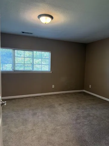 an empty room with closet area