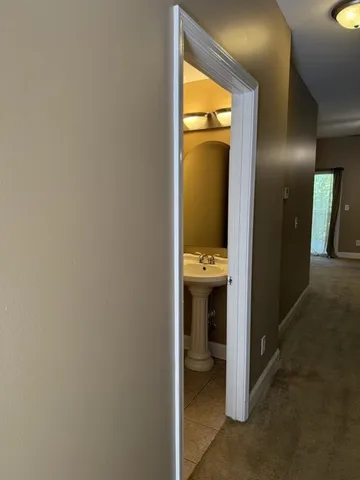 a view of a room with a ceiling fan and window