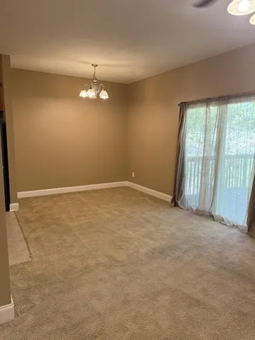 wooden floor in an empty room with a kitchen