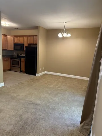 a kitchen with a sink a window and cabinets