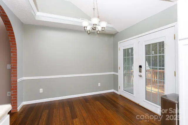 a view of wooden floor and windows in a room