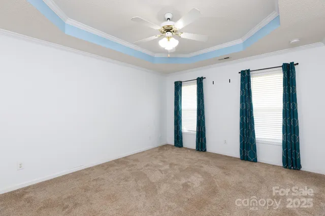 a view of a room with a ceiling fan and a window