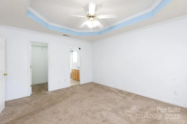 an empty room with a ceiling fan and a window