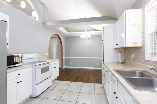 a kitchen with a sink stove and cabinets