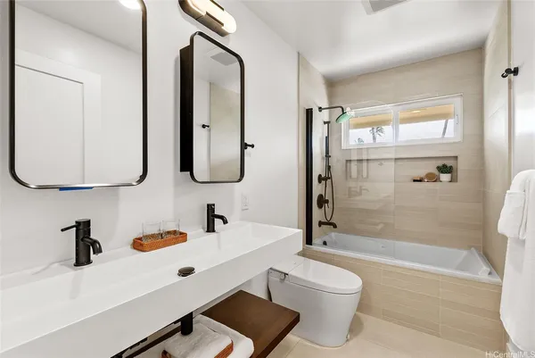 a bathroom with a double vanity sink toilet mirror and shower