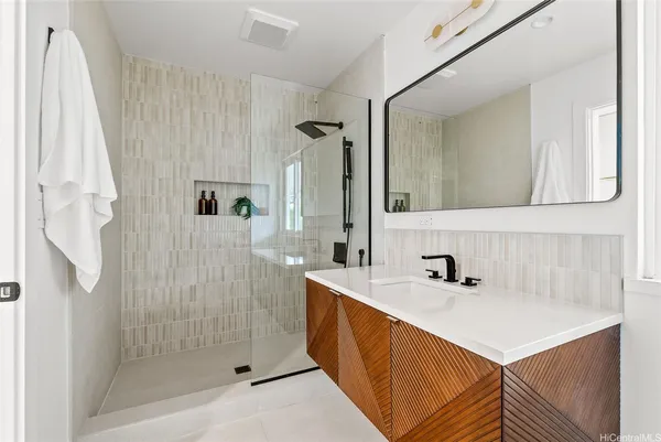 a view of a patio with table and chairs potted plants and floor to ceiling window and potted plants