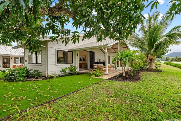 a view of a house with backyard porch and sitting area
