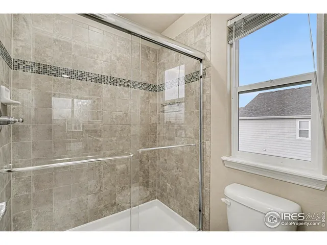 a big white house with a big yard and large trees