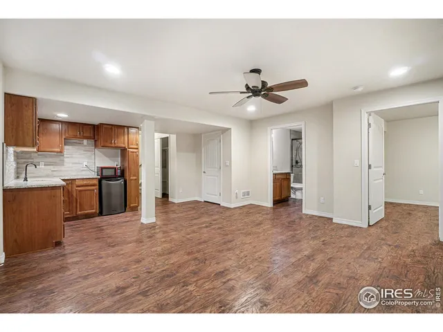 a kitchen with stainless steel appliances kitchen island granite countertop a stove a sink and a refrigerator