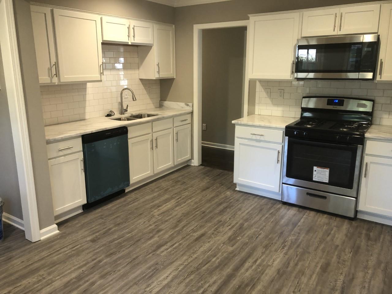 1154 West Perkins Road Memphis, TN 38117 - Photo 2 of 7 a kitchen with a sink and a stove top oven