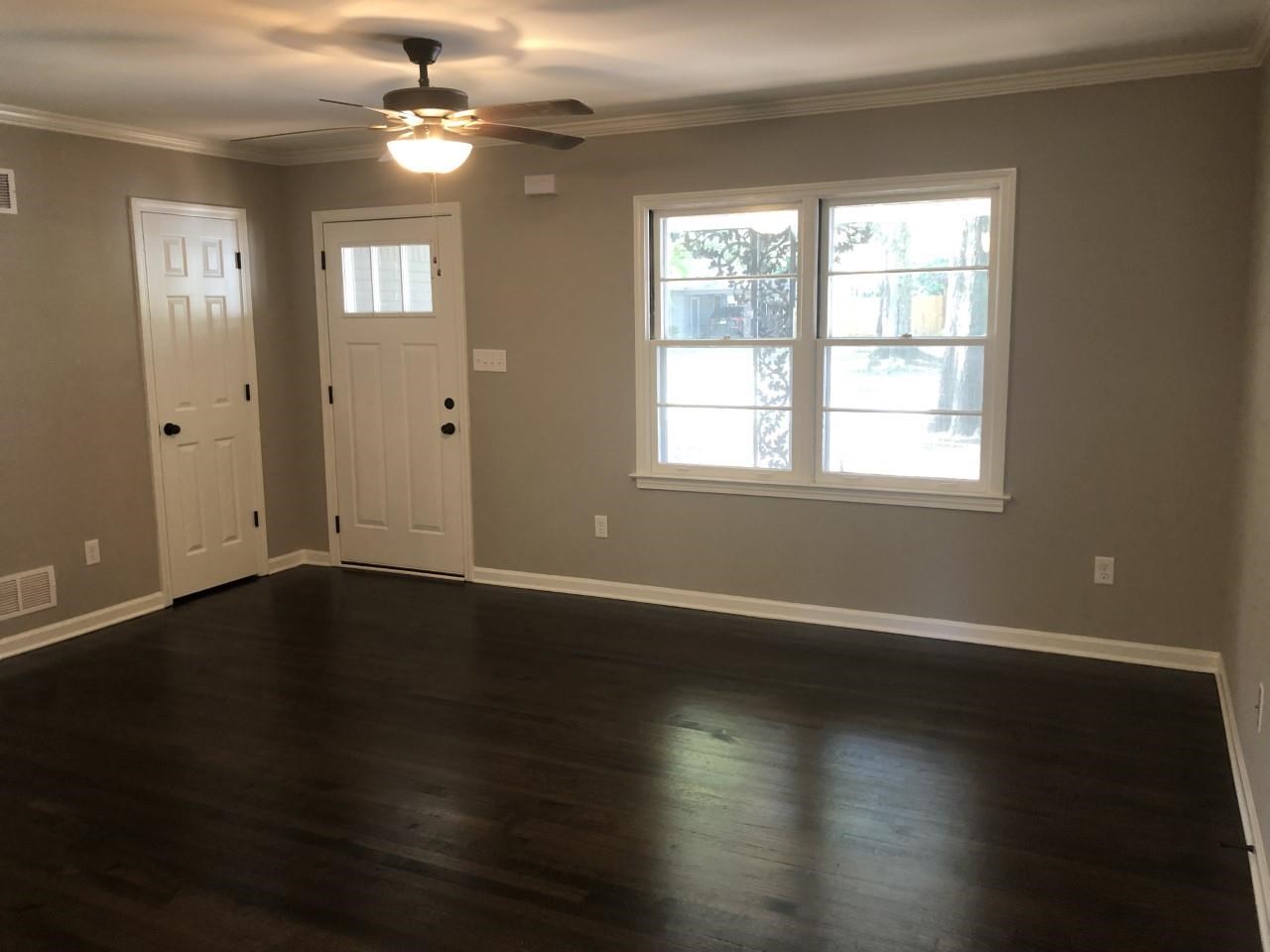 1154 West Perkins Road Memphis, TN 38117 - Photo 5 of 7 an empty room with wooden floor and windows