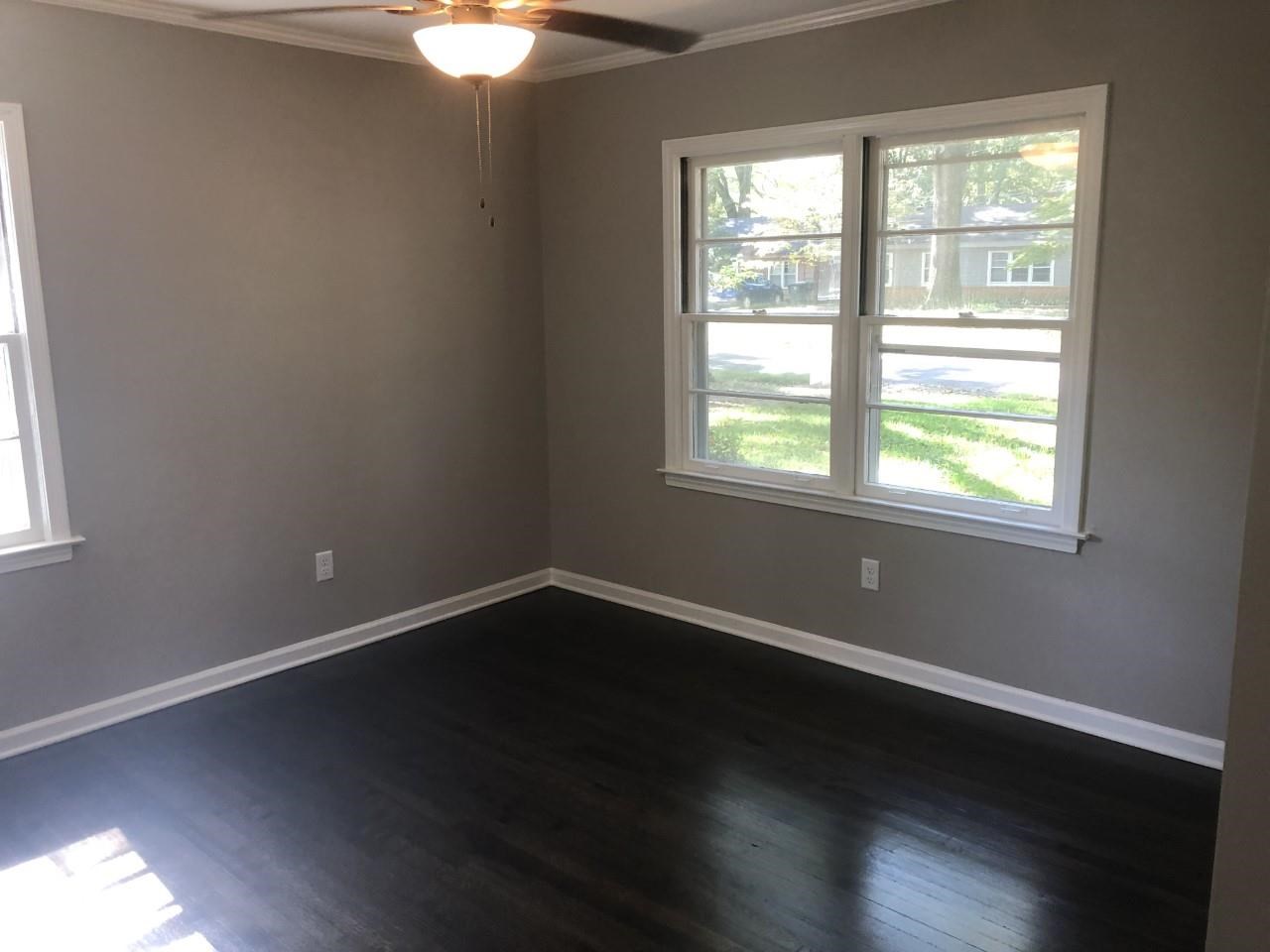 1154 West Perkins Road Memphis, TN 38117 - Photo 7 of 7 a view of an empty room with wooden floor and a window