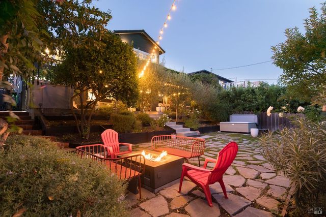 a backyard of a house with table and chairs