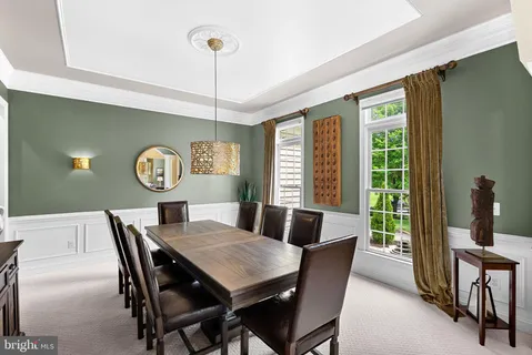 a living room with furniture and floor to ceiling windows