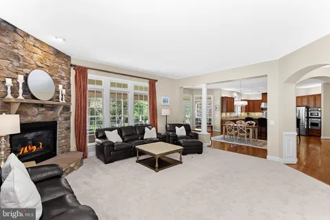 a view of a hallway with living room and wooden floor