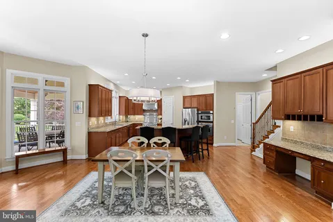 a large kitchen with a large counter top and stainless steel appliances