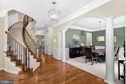 a view of a livingroom with wooden floor and furniture