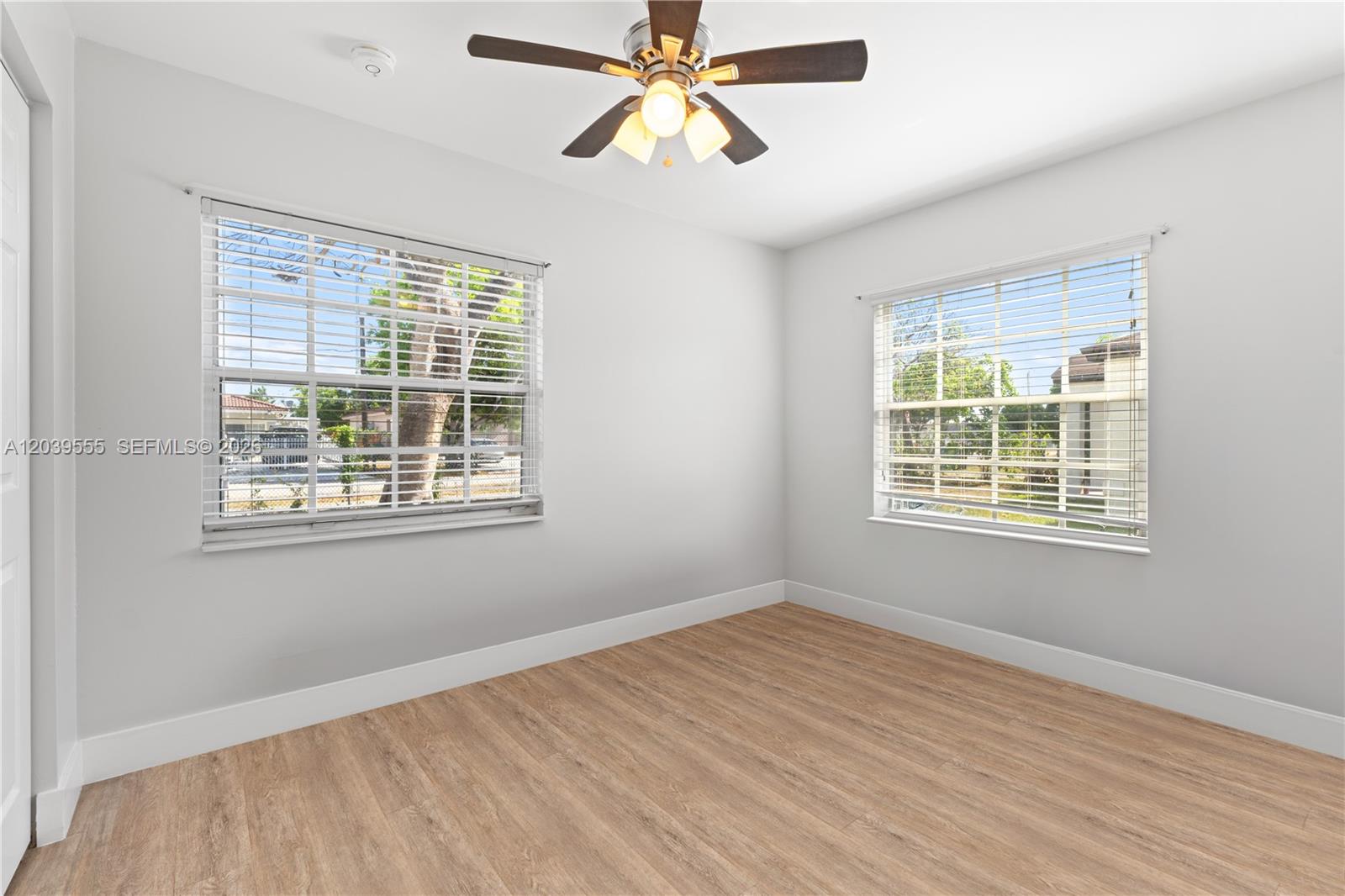 10544 Southwest 182nd Street Miami, FL 33157 - Photo 6 of 15 a view of an empty room with window and wooden floor