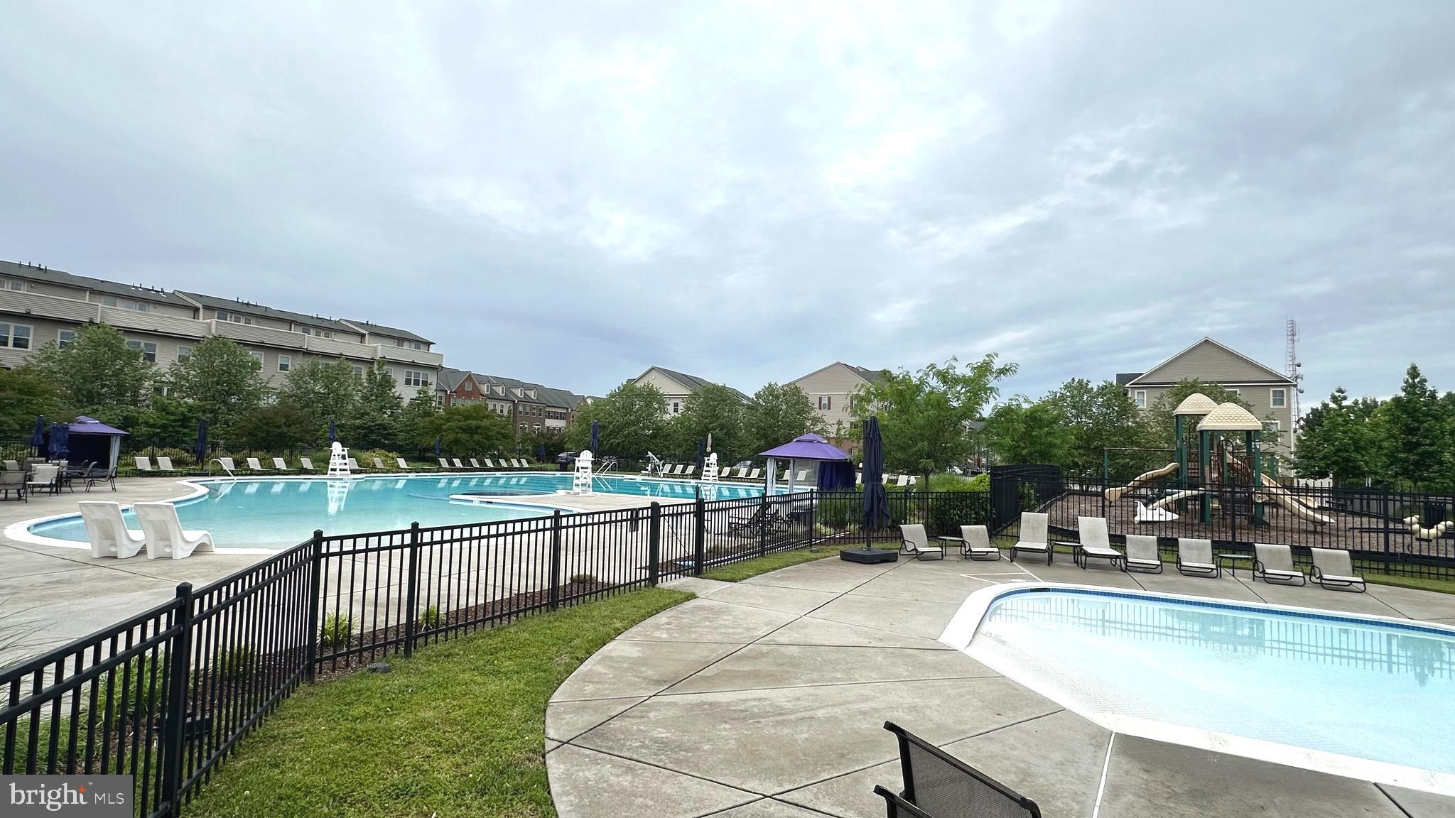 7343 Old Calvary Road Hanover, MD 21076 - Photo 33 of 35 a view of a swimming pool with a lounge chairs