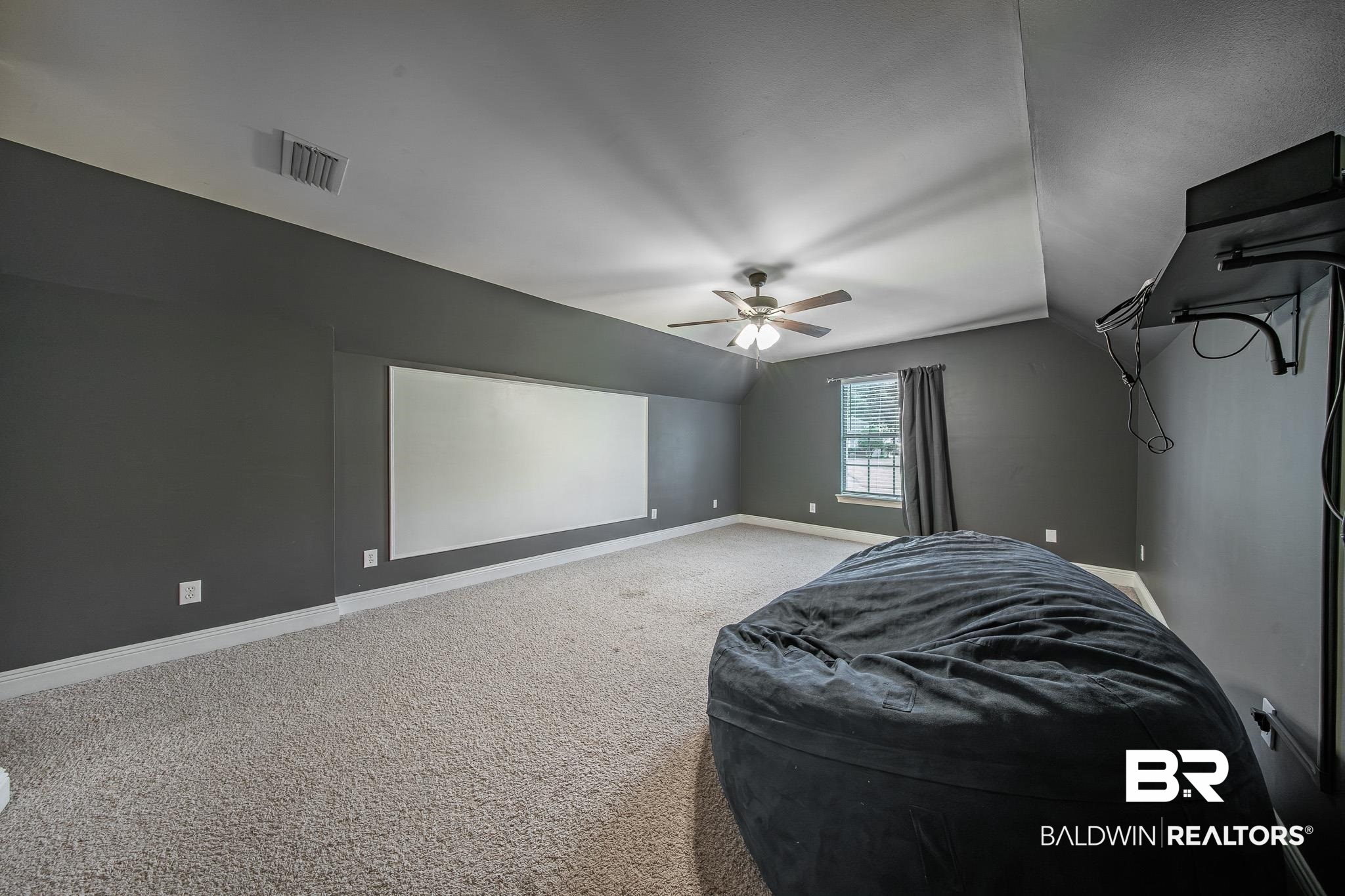 8421 Weatherford Court Daphne, AL 36527 - Photo 30 of 36 Home theater room featuring carpet flooring, lofted ceiling, and ceiling fan