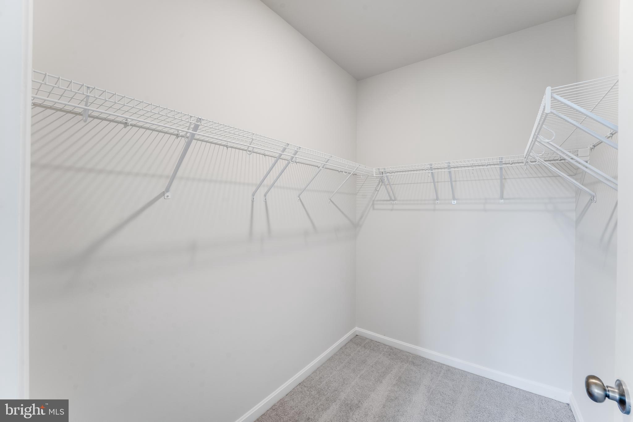 4003 Seaside Alder Road, Unit 208 ROSE Bowie, MD 20720 - Photo 16 of 18 a view of a room with racks on the wall