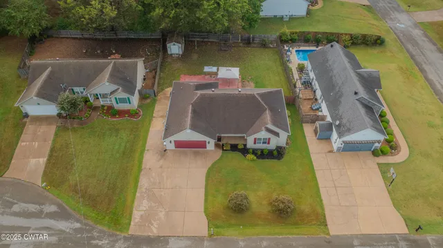 an aerial view of a house with a swimming pool