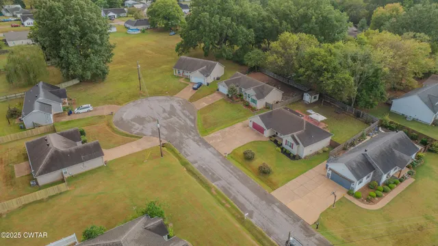 an empty room with wooden floor and mirror
