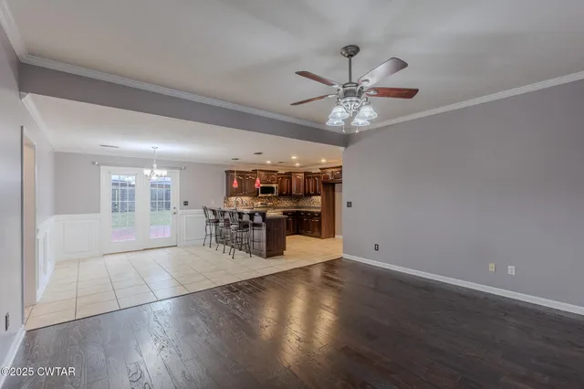 a view of a dining room with furniture and chandelier