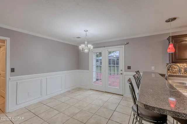 a kitchen with stainless steel appliances kitchen island granite countertop a sink and a cabinets
