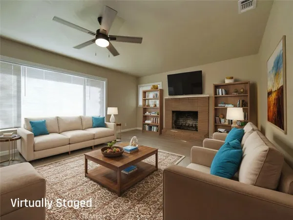 a living room with furniture a flat screen tv and a fireplace