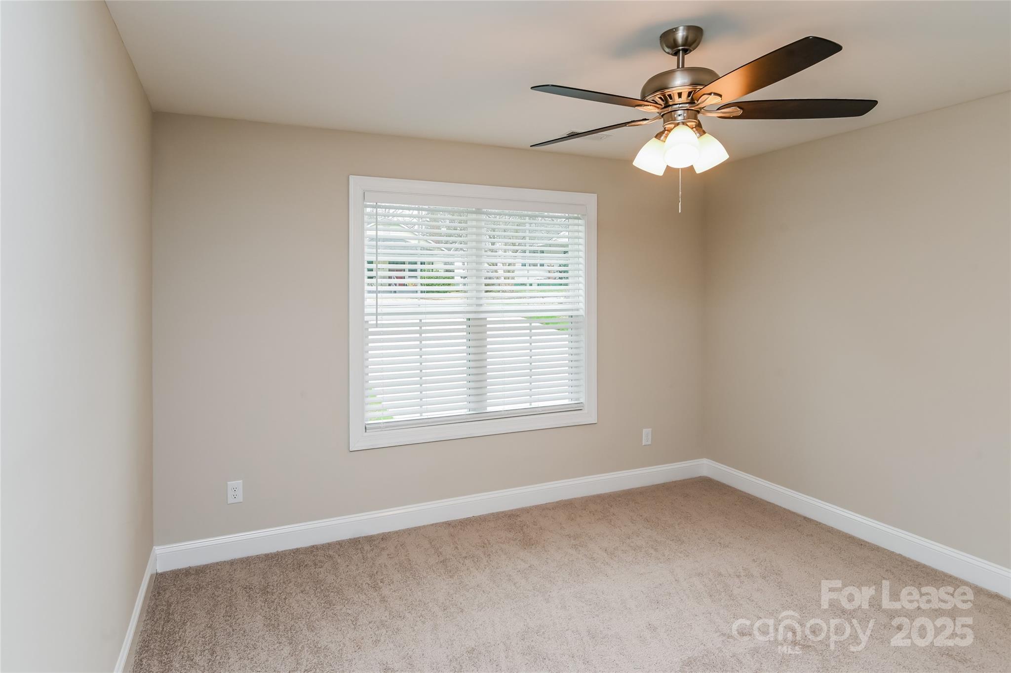 131 Powder Street Southwest Concord, NC 28025 - Photo 11 of 14 an empty room with a window and a fan
