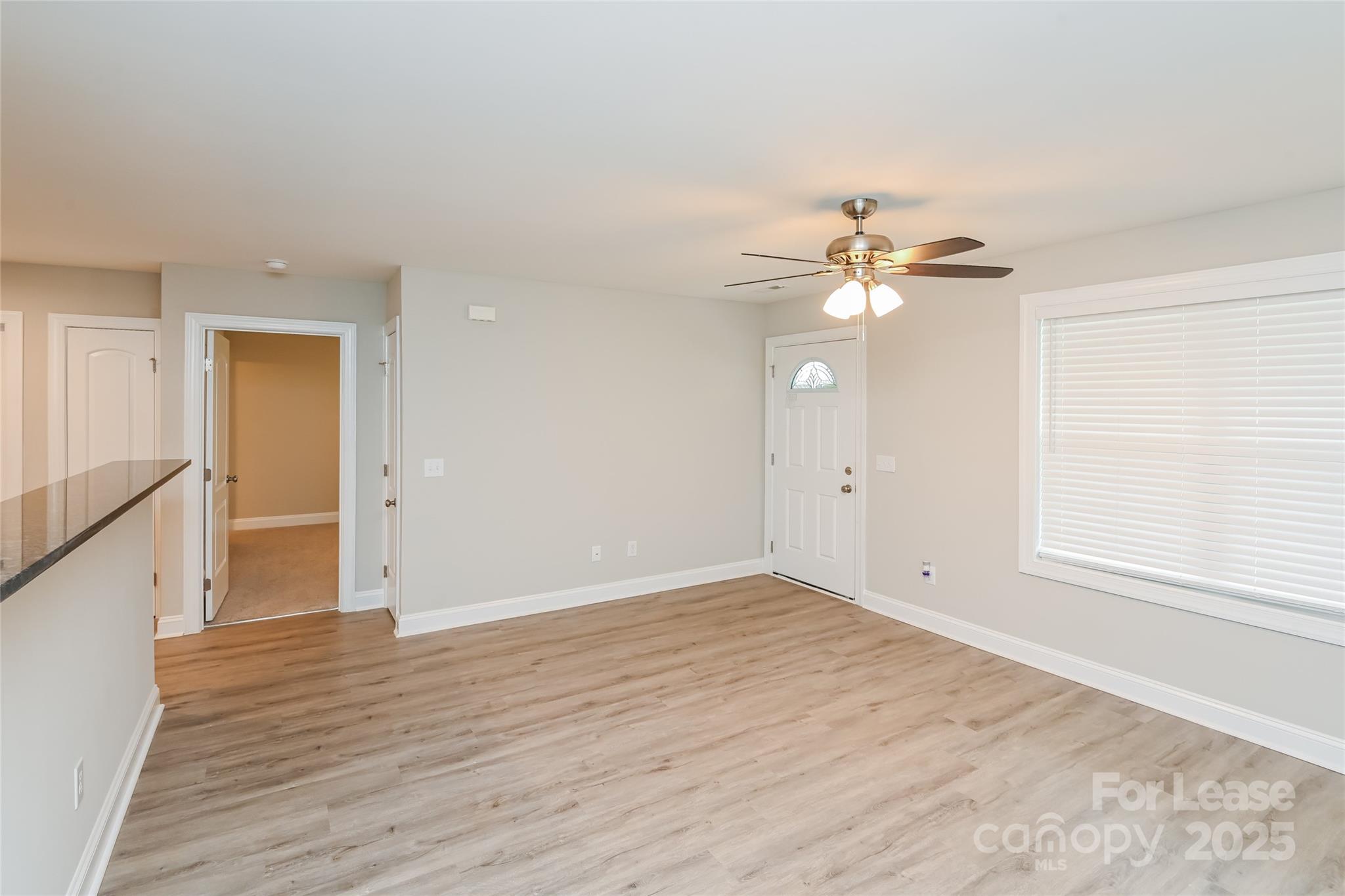 131 Powder Street Southwest Concord, NC 28025 - Photo 5 of 14 wooden floor in an empty room with a window