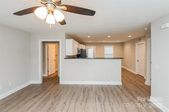 a view of kitchen with cabinets and wooden floor