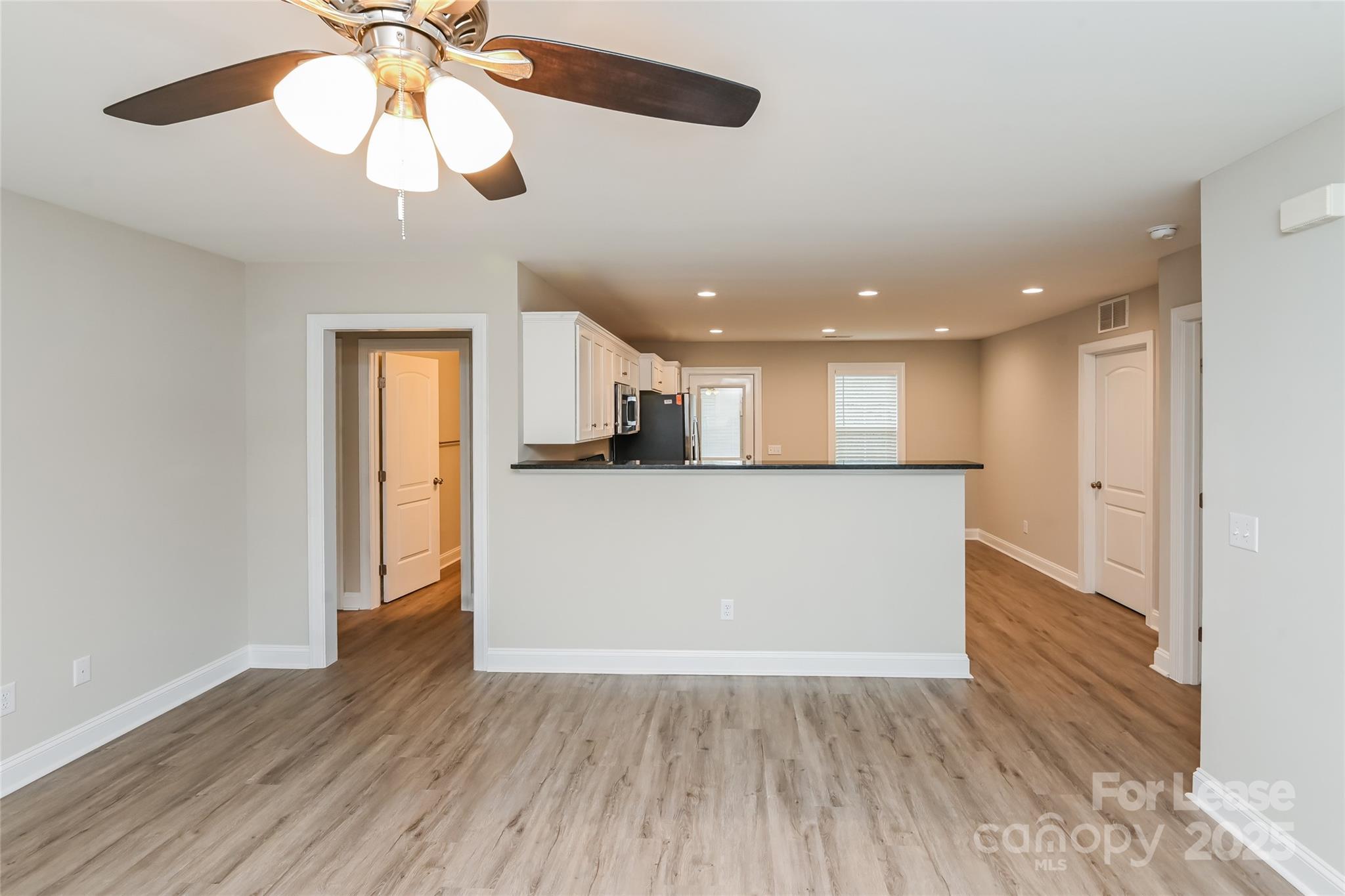 131 Powder Street Southwest Concord, NC 28025 - Photo 6 of 14 a view of kitchen with cabinets and wooden floor