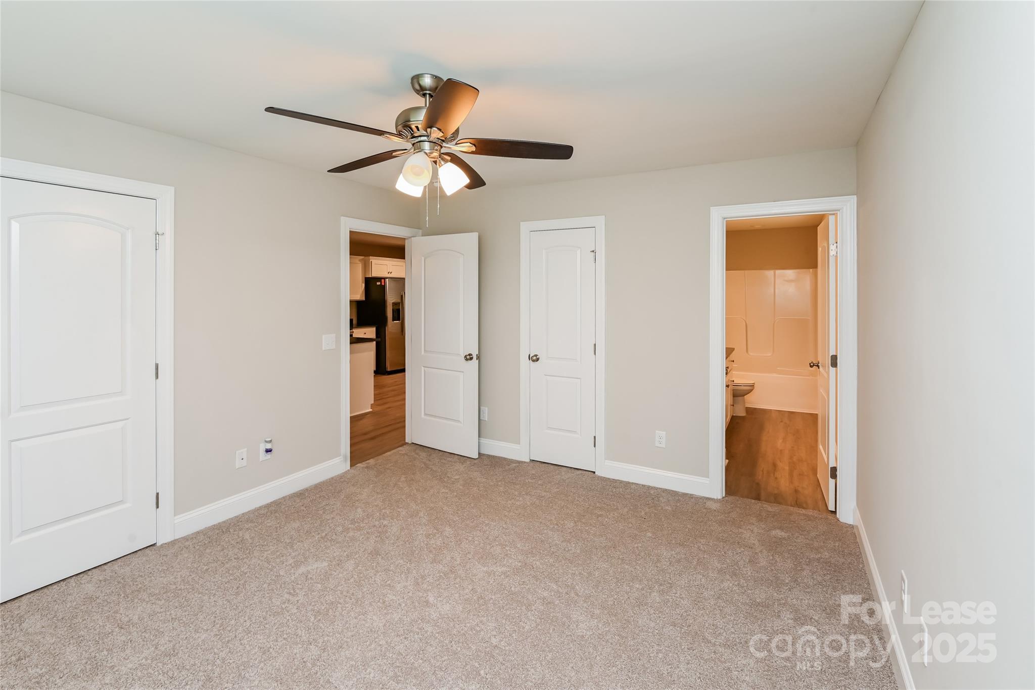 131 Powder Street Southwest Concord, NC 28025 - Photo 7 of 14 an empty room with closet and a chandelier fan