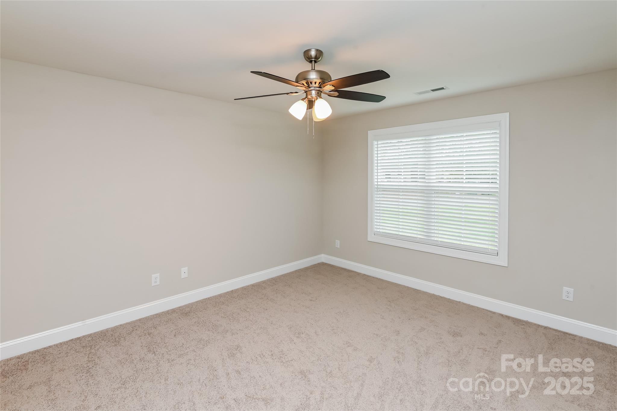 131 Powder Street Southwest Concord, NC 28025 - Photo 8 of 14 an empty room with a window and a fan