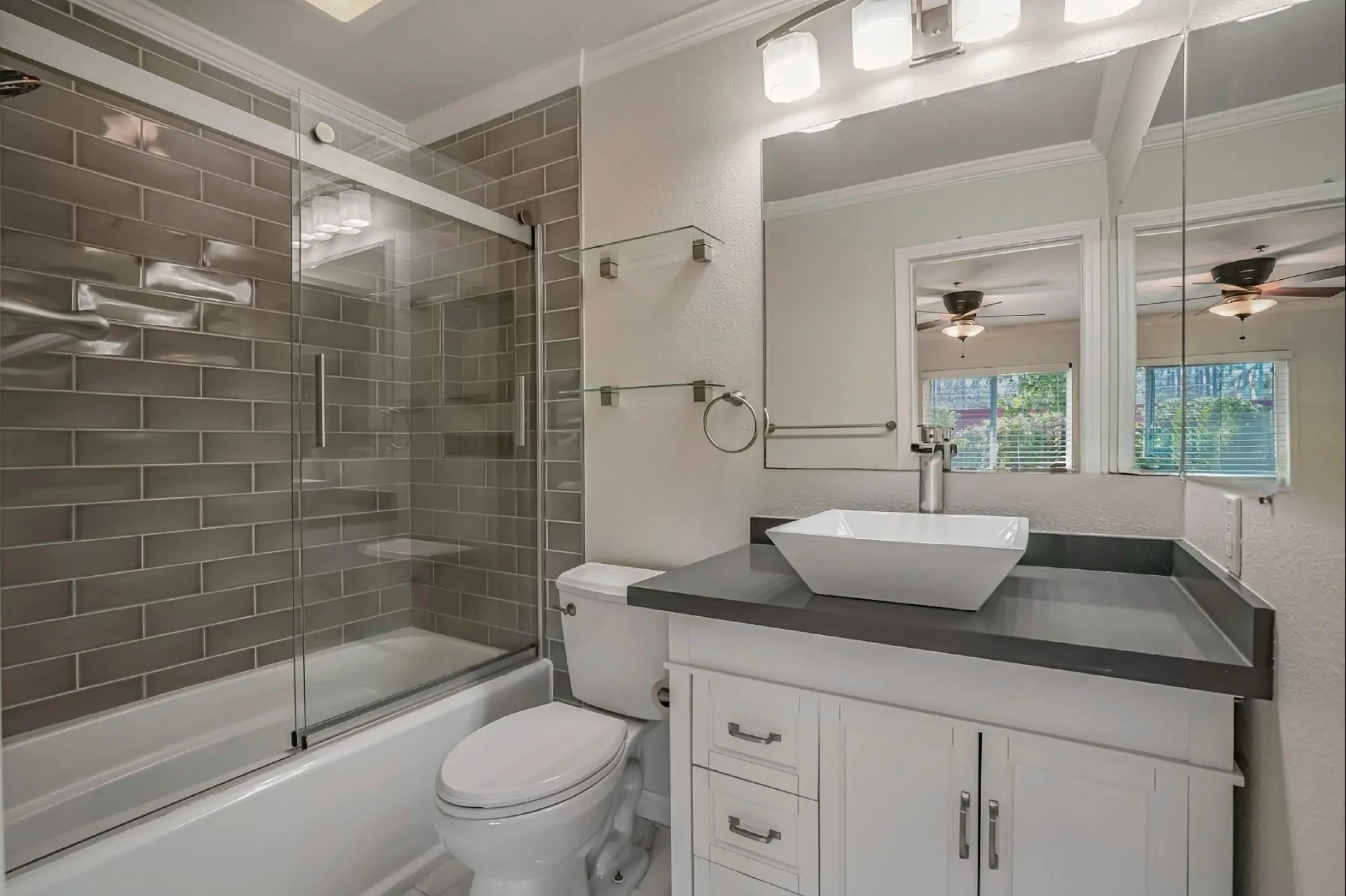 139 Mangano Circle Encinitas, CA 92024 - Photo 11 of 18 a bathroom with a granite countertop sink a toilet a mirror and shower