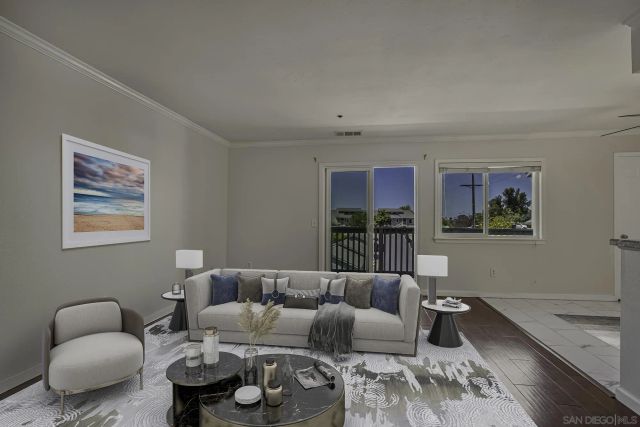 a living room with furniture and painting on the wall