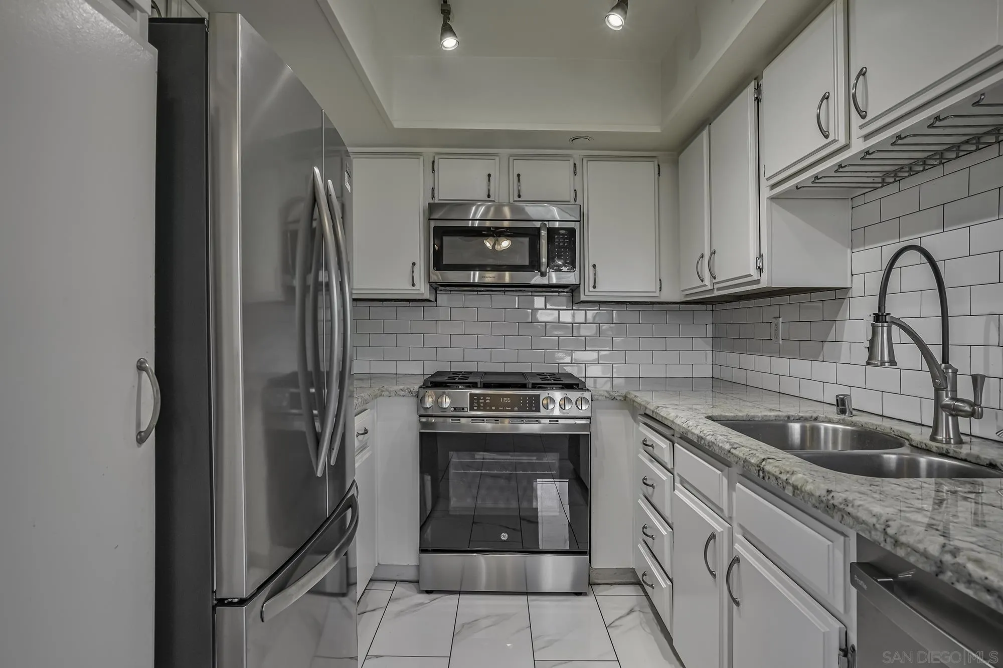 139 Mangano Circle Encinitas, CA 92024 - Photo 8 of 18 a kitchen with granite countertop a stove sink and refrigerator