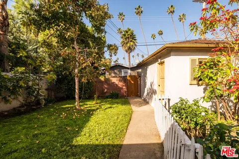 a view of a pathway of a house with a garden