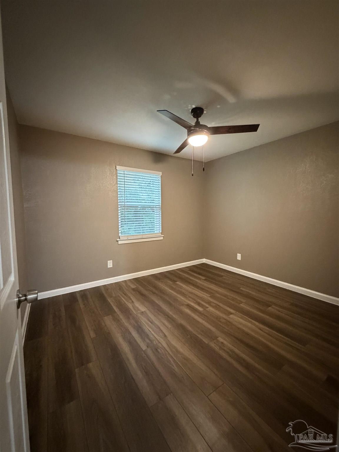 932 Fremont Avenue Pensacola, FL 32505 - Photo 14 of 16 a view of an empty room with wooden floor and a window