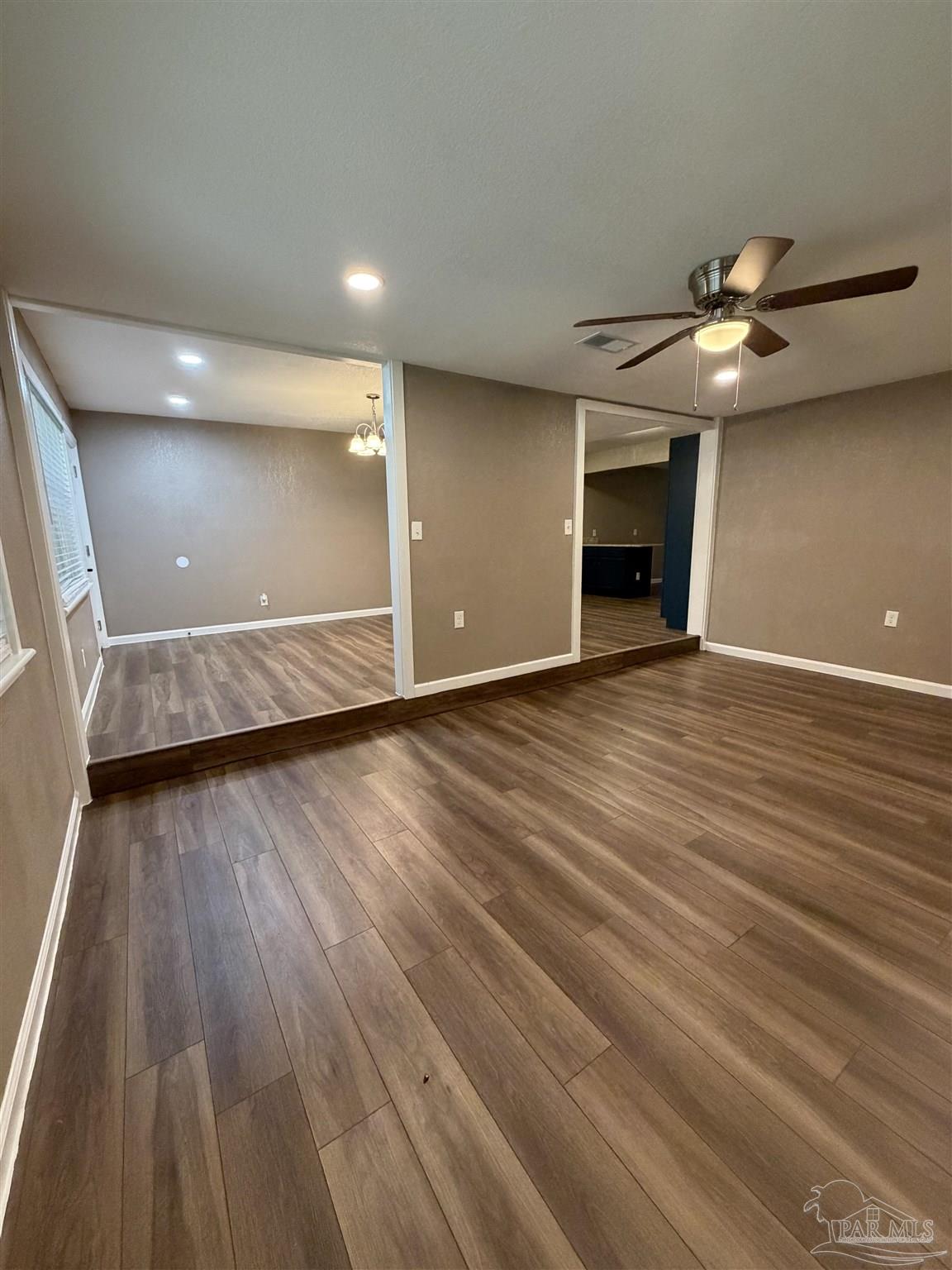932 Fremont Avenue Pensacola, FL 32505 - Photo 5 of 16 wooden floor in an empty room with a window