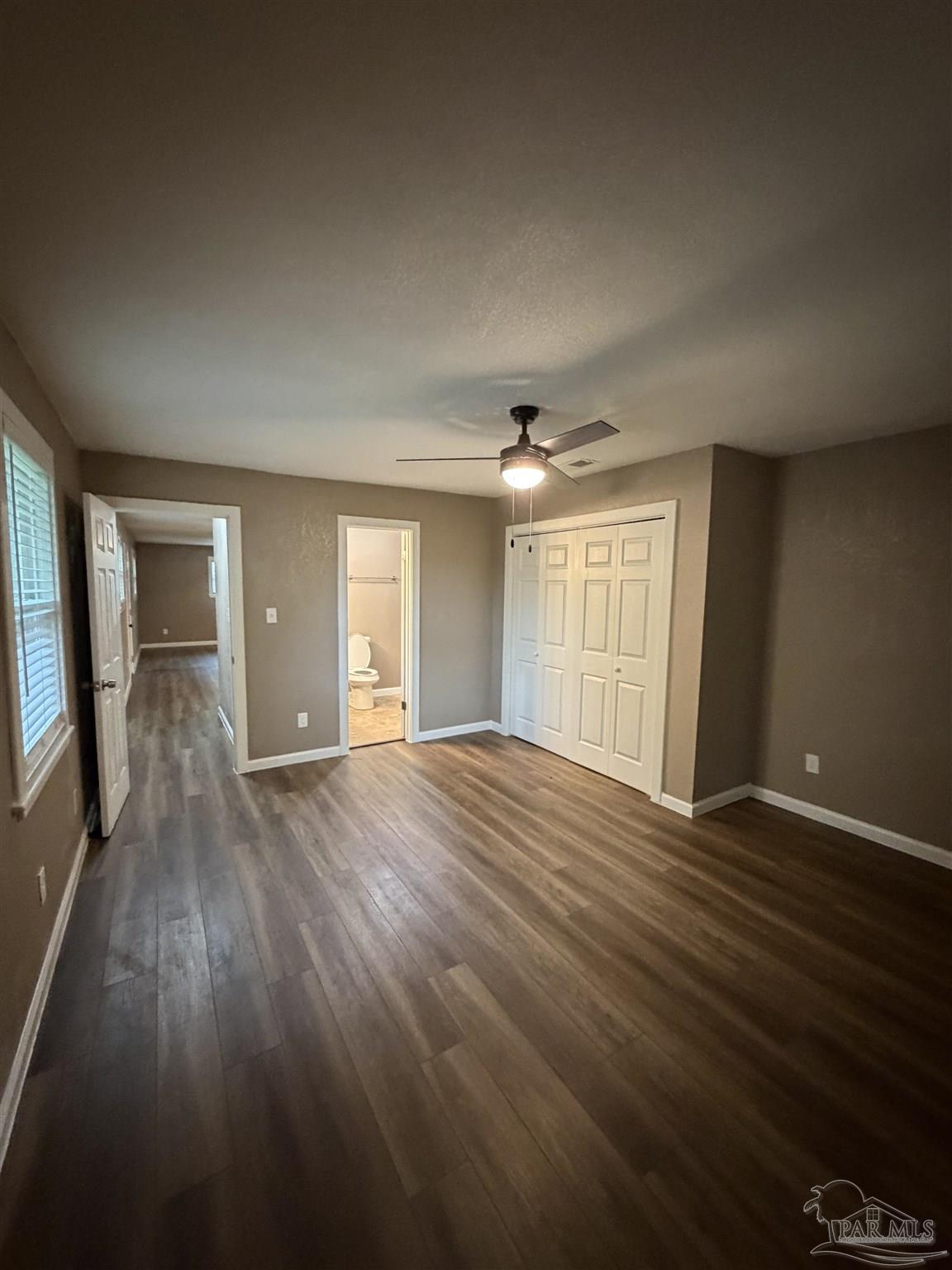 932 Fremont Avenue Pensacola, FL 32505 - Photo 10 of 16 a view of an empty room with wooden floor and a window